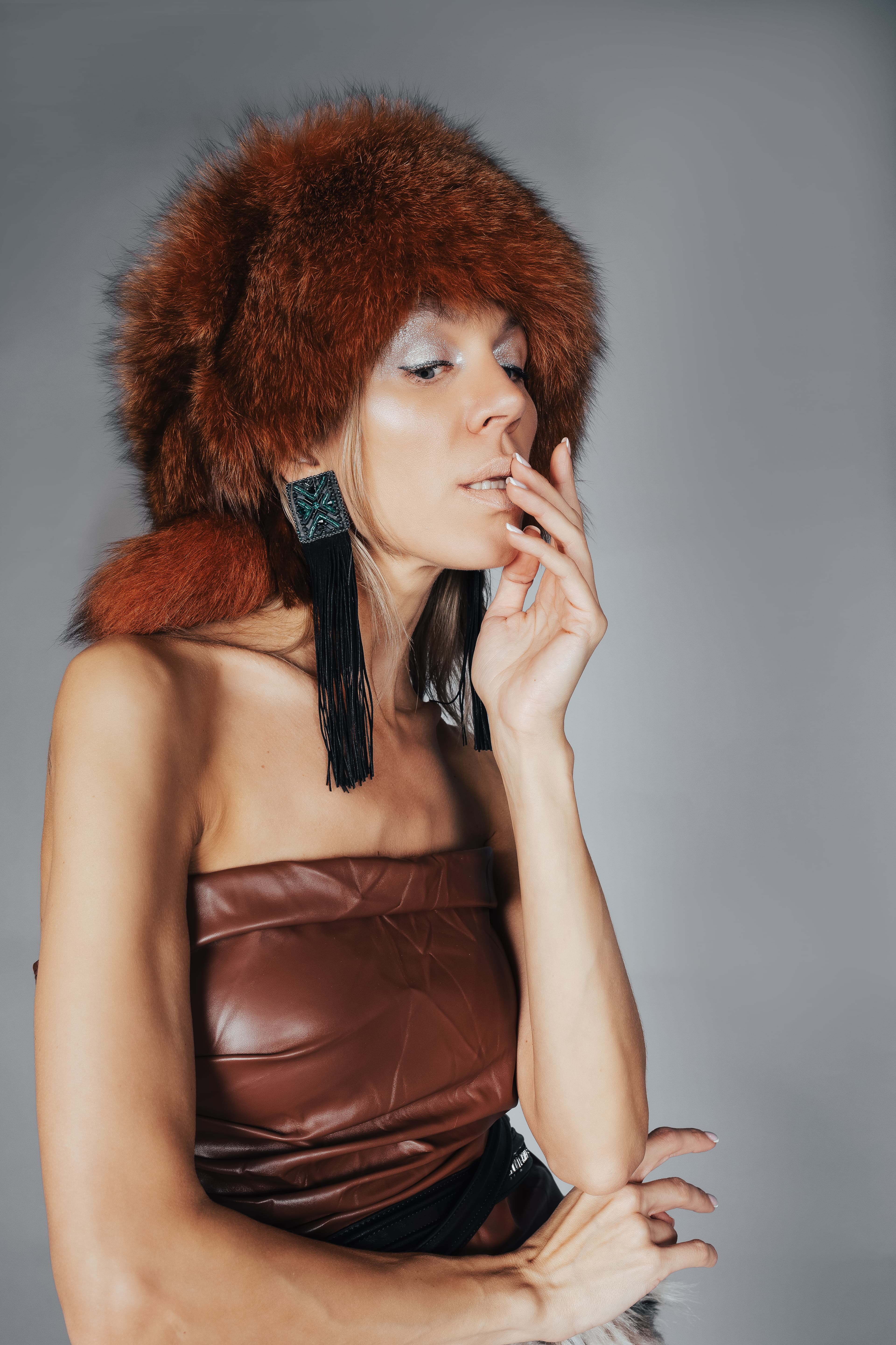 Portrait of Sofia Solas wearing a russet fur hat